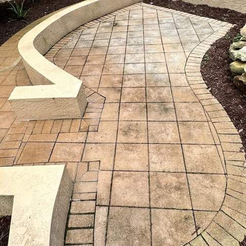 Stained paver patio before pressure washing